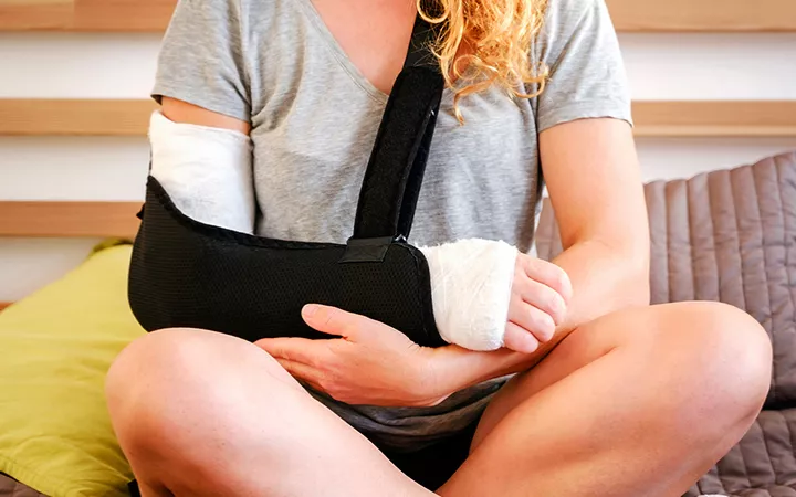 Frau mit einem verletzten Arm