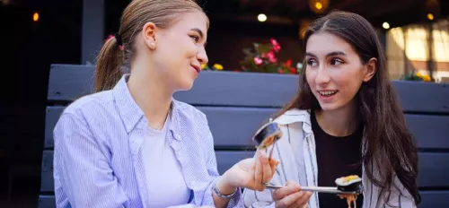Zwei Girls die zusammen Sushi essen